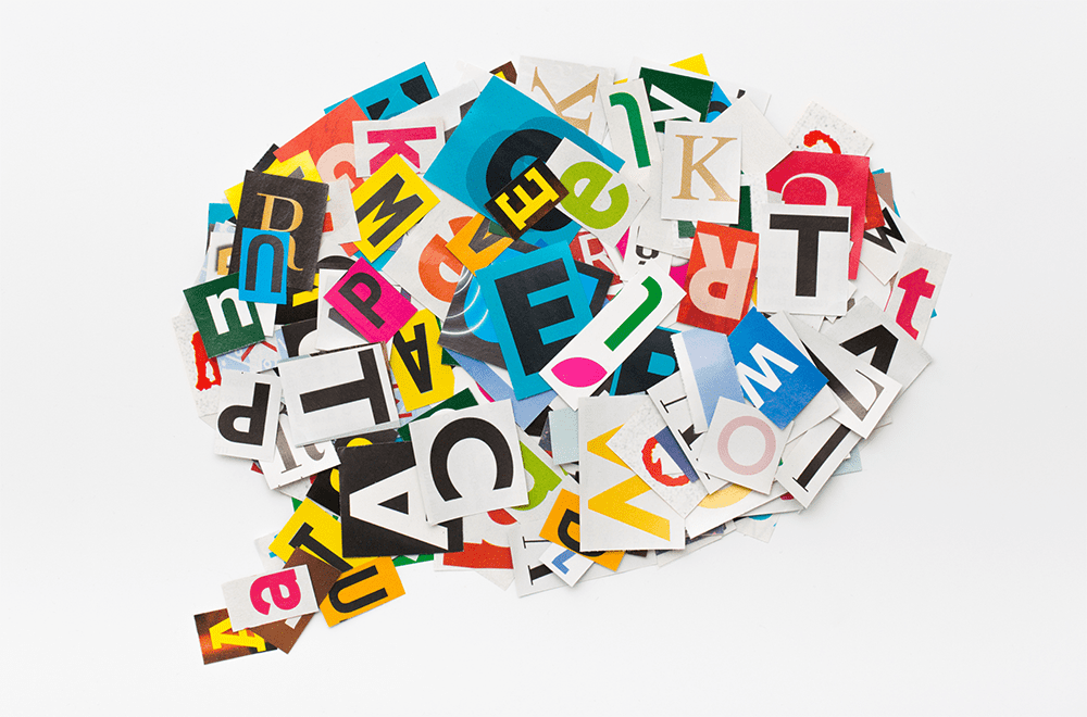 Cut-out letters organised in the shape of a brain