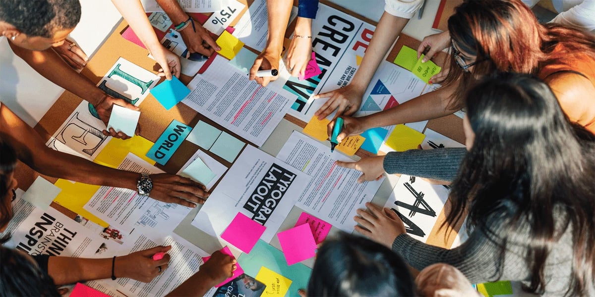 Group of people around a table working on creative project