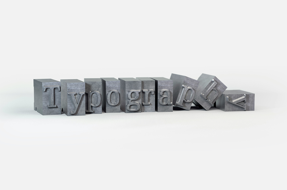 Small steel blocks with engraved letters that spell Typography