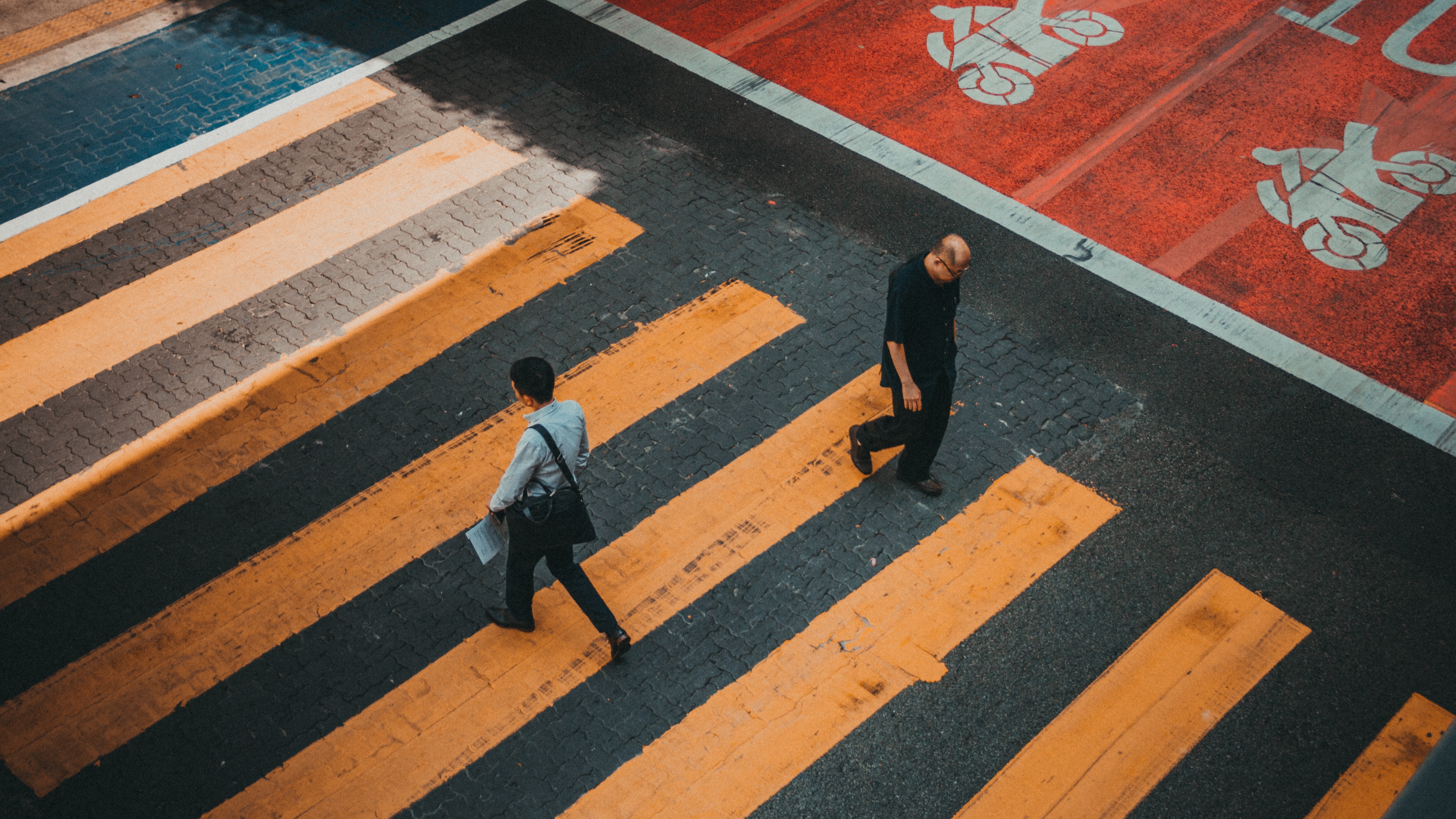 Men walking on zebra crossing